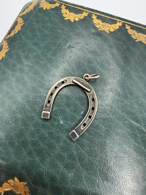 Vintage Sterling Silver Horseshoe Charm Pendant: Vintage Sterling Silver Horseshoe Charm Pendant marked sterling on back with '81. Measuring approximately 1 inch long including bail.