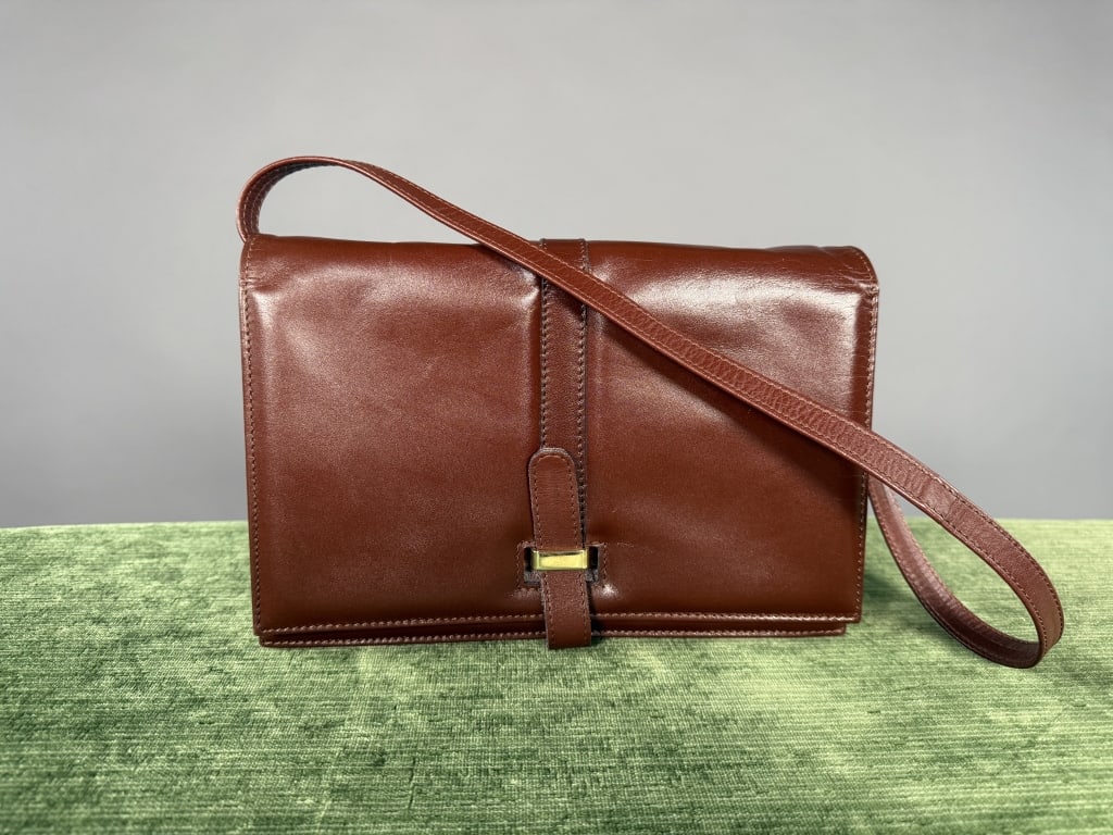 Vintage 1960s Sacha Leather Satchel Bag Purse: Vintage 1960s Sacha Leather Satchel Bag Purse having accordion design with strap and metal loop closure at front. Two interior sections with two pockets, one zippered. Adjustable shoulder strap. Measu