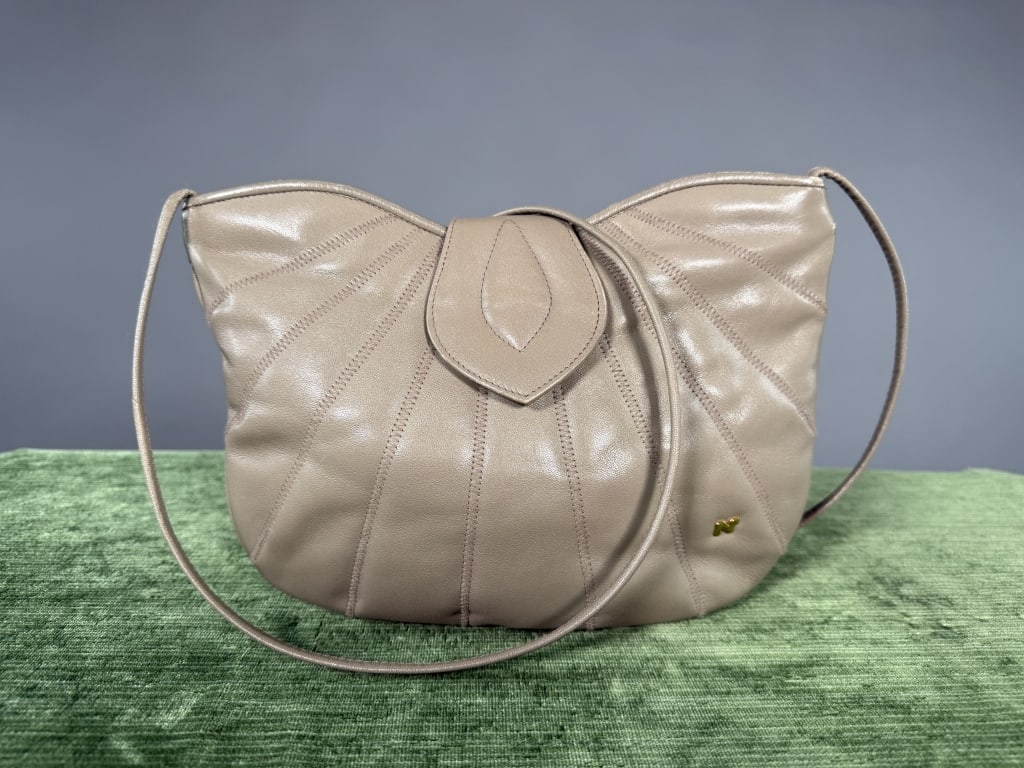 Vintage 1970s Nina Ricci Leather Seamed Purse: Vintage 1970s Nina Ricci Leather Seamed Purse Bag having zig-zag stitching throughout with metal monogram logo at front and magnetic snap closure. Zips at top to close with one interior zippered pocke