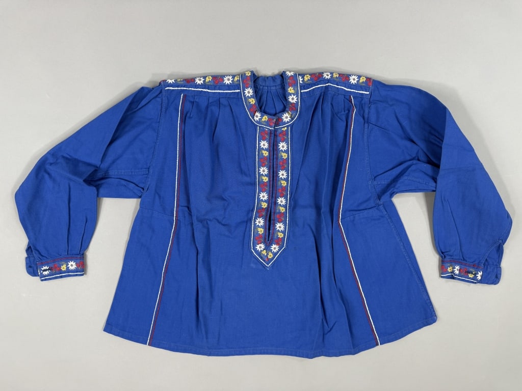 Vintage 1970s Blue Cotton Floral Print Folk Blouse: Vintage 1970s Blue Cotton Floral Print Folk Blouse having original plastic bag, in deadstock NOS new-old-stock condition. Bordered with floral ribbon details throughout and snap closure at neck. Measu