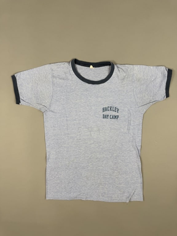 Vintage 1970s Hackley Day Camp Blue Ringer Tee: Vintage 1970s Hackley Day Camp Blue Ringer Tee Shirt Top having graphic at chest & contrast ribbing at neck and sleeve cuffs. Measuring 19 inches flat across chest, 25 inches long, 7 inch sleeve lengt