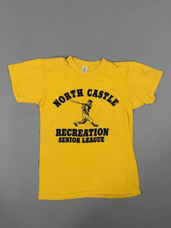Vintage 1970s North Castle Recreation Tee Shirt: Vintage 1970s North Castle Recreation Tee Shirt having NORTH CASTLE RECREATION SENIOR LEAGUE graphic at front. Tag marked all cotton. Measuring 16 inches flat across chest, 22 inches long, 5 inch slee