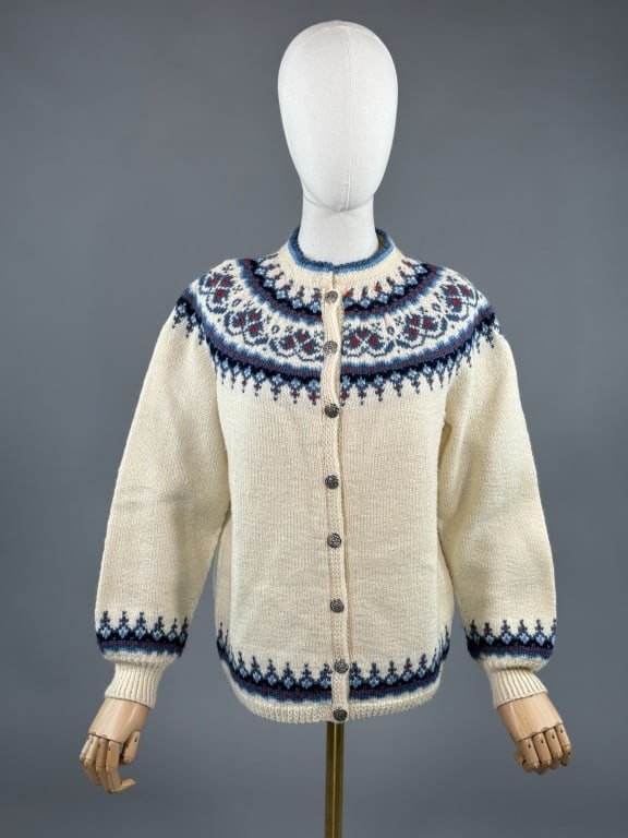 Vintage 1970s Norwegian Fair Isle Knit Sweater: Vintage 1970s Norwegian Fair Isle Knit Cardigan Sweater having Norwegian pattern knit around neck, hem, and sleeve cuffs. Closing at center front with metal buttons. Tagged Norsk Husflid - 100% wool.