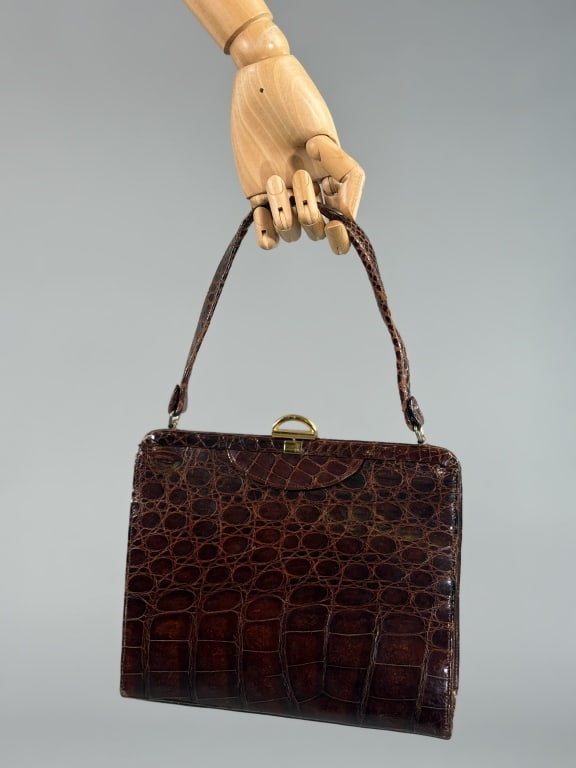 Vintage 1950s Brown Alligator Leather Hand Bag: Vintage 1950s Brown Alligator Leather Hand Bag Purse having self covered metal frame lock closure at top with short handle. Light wear to handle as shown. Leather lined with two inner pockets, one zip