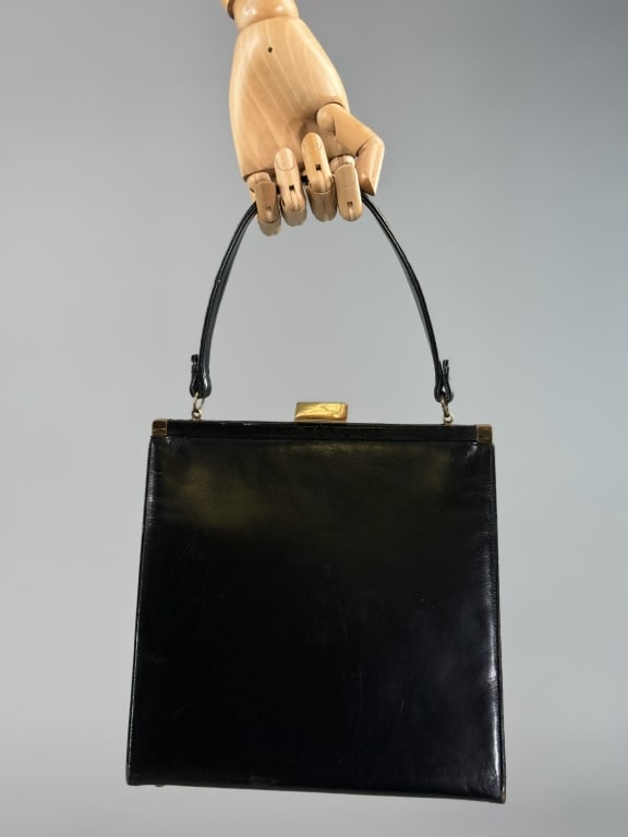 Vintage 1950s Coblentz Black Box Leather Hand Bag: Vintage 1950s Coblentz Black Box Leather Hand Bag having rigid shape with metal frame closure at top and short handle. Interior divided into two sections with kiss lock closure at center and zippered