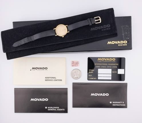 Vintage Ladies Movado Swiss Watch w Original Box: Vintage Ladies Movado Swiss Watch w Original Box & Dust Cover. Gold tone. Watch face / case measures approximately 1.25 inches in length. Largest size on leather bracelet wears as approximately 7 inch