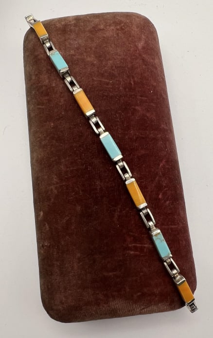 Native American Turquoise & Sterling Bracelet: Vintage Native American Style Turquoise & Sterling Silver Articulated Panel Bracelet. Hallmarked clasp. Measures 7.75 inches in length approximately.