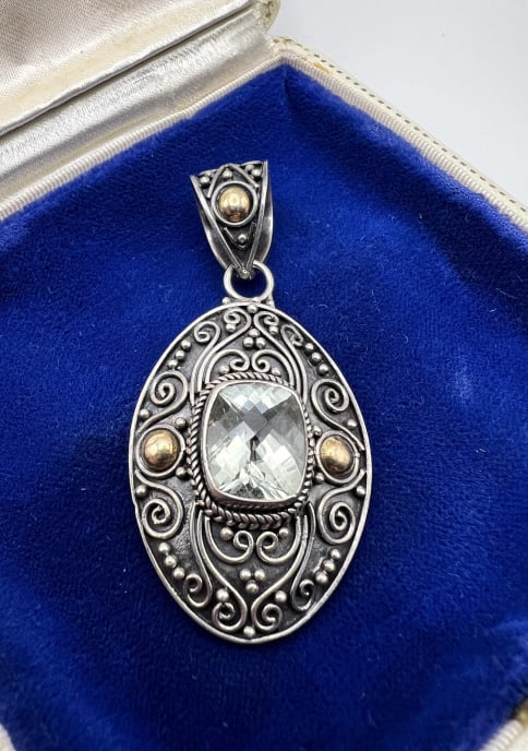 18kt Yellow Gold Sterling & Topaz Necklace Pendant: 18kt Yellow Gold Sterling & Topaz Necklace Pendant. Signed and hallmarked 18k 925 on the back. Bezel set with a briolette cut gemstone that tests as topaz on the Presidium. Measures 2.25 inches in len