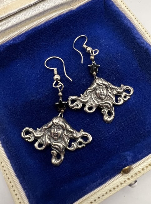 Pair of Sterling & Hematite Art Nouveau Earrings: Pair of Sterling & Hematite Art Nouveau Earrings. Art Nouveau style portrait pendants of ladies with flowing hair, carved hematite star bead. Each measures just over 2 inches in length.