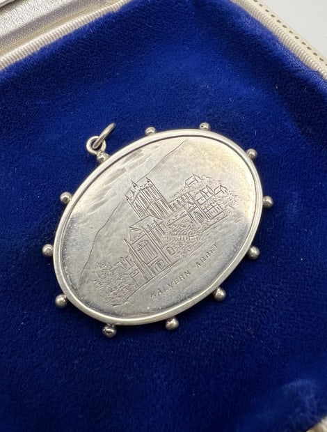 Antique 19th C Sterling Pendant of Malvern Abbey: Antique 19th C Sterling Pendant of Malvern Abbey. Antique 19th C Victorian era sterling silver English necklace pendant with chased engraved scene of Malvern Abbey, in Worcestershire, England, which w