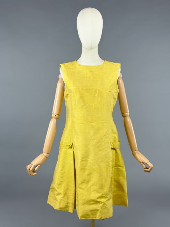 Vintage 1960s Raw Silk Pleated Sleeveless Dress: Vintage 1960s Raw Silk Pleated Sleeveless Dress having A-line shape with belted beaded button details at hips with pleated hem and center back zip closure. Measuring 36 inch bust, 34 inch waist, 36 in