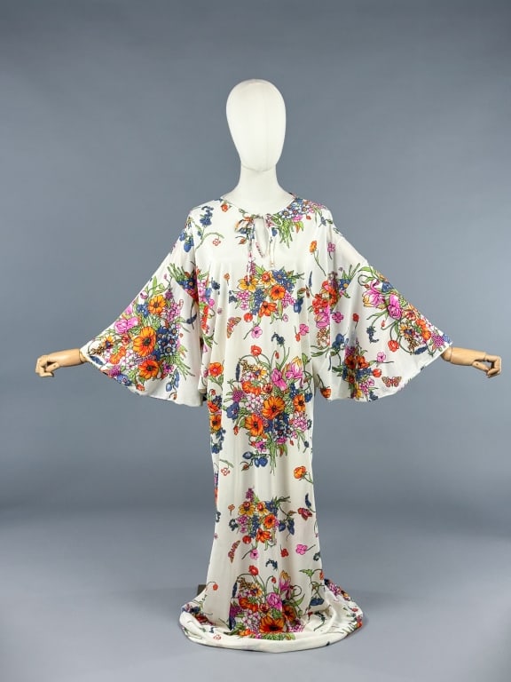 Vintage 1970s Floral Bouquet Maxi Kaftan Dress: Vintage 1970s Floral Bouquet Knit Maxi Kaftan Dress having all over rainbow floral bouquet pattern with tie at neck and loose fit throughout. Measuring free bust/waist, 59 inches long, 12 inch sleeve