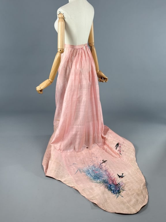 Antique Raw Silk Hand Painted Trained Skirt: Antique Raw Silk Hand Painted Trained Skirt having hand painted bird and floral train with hook closure at center back and ruched waist. Measuring 26 inch waist, 41 inch front length, 67 inch back len