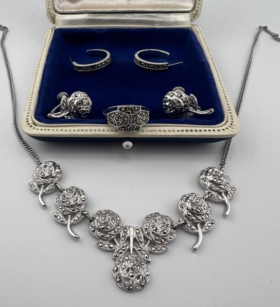 Group Vintage Marcasite Jewelry Incld Sterling: Collection of Vintage Marcasite Jewelry Including Sterling Silver. Matching rose motif necklace and earrings, hoop earrings, ring. Ring is hallmarked. Ring is approximately size 6
