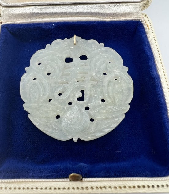 Chinese Vintage Hand Carved Jade Necklace Pendant: Chinese Vintage Hand Carved Jade Necklace Pendant. Carved with face at top, character at center, fruit and leaves at bottom, scrollwork on sides. Measures 2 inches in diameter.