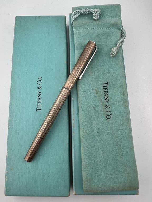 Tiffany & Co Sterling Silver Pen with Original Box: Tiffany & Co Sterling Silver Pen with Original Box as well as Dust Cover. Signed and hallmarked. Pen measures approximately 5 inches in length, box measures approximately 7 inches in length.
