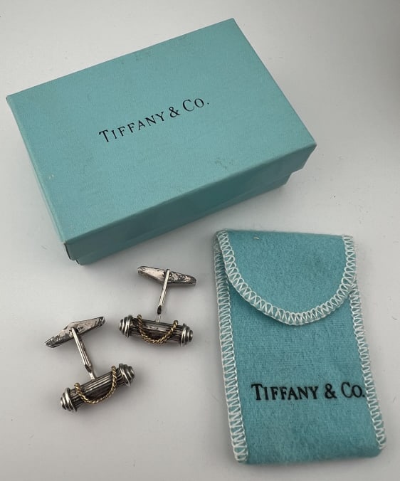 Tiffany & Co Sterling Silver & 18kt Gold Cuff Link: Pair of Tiffany & Co Sterling Silver & 18kt Gold Cuff Links. With original box and dust cover. These are signed TIFFANY & CO 925 and 750. Each measures 1 inch in width and depth. Box measures approxim