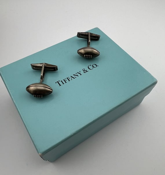 Tiffany & Co Sterling Silver Football Cuff Links: Pair of Tiffany & Co Sterling Silver Football Cuff Links. Signed TIFFANY & CO 925. The football portions are .75 of an inch, the cuff links are approximately 1 inch in length. Box measures approximate