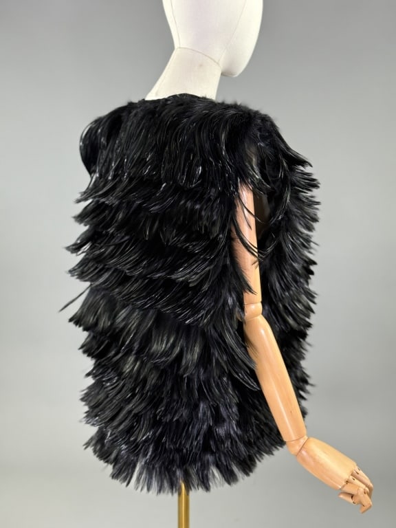 Vintage 1960 Black Feather French Couture Vest Top: Vintage 1960s Black Feather French Couture Vest Top having rows of feathers throughout with satin lining and single hook closure at neck. Labeled Made in France for Rita Jamie, Inc. Measuring approxim