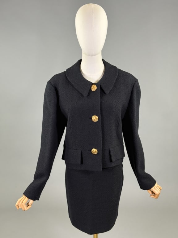 Vintage 1980s Isani New York Black Wool Skirt Suit: Vintage 1980s Isani New York Black Wool Skirt Suit Set with jacket having cropped style closing at center front with gold tone metal buttons and non functional pocket flaps at hem. Skirt having center