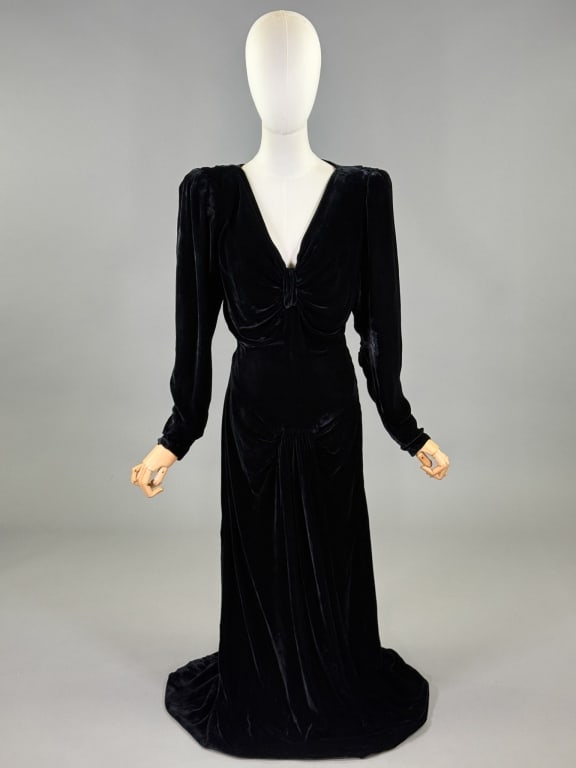 Vintage 1940s Black Velvet Draped Evening Gown: Vintage 1940s Black Velvet Draped Evening Gown having plunging neckline with draped detail at bust and drop waist, closing at side with zip and bias cut with stretch. Measuring 34 - 40 inch bust, 28 -
