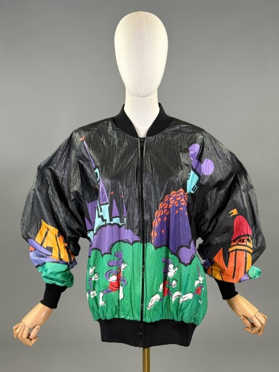 Vintage 1990s Tyvek Disney World Bomber Jacket: Vintage 1990s Tyvek Disney World Bomber Jacket having zip front closure with ribbed knit collar, sleeve cuffs, and hem. Mickey Mouse & Disney print, back reads 95 Marathon Walt Disney World. Marked si