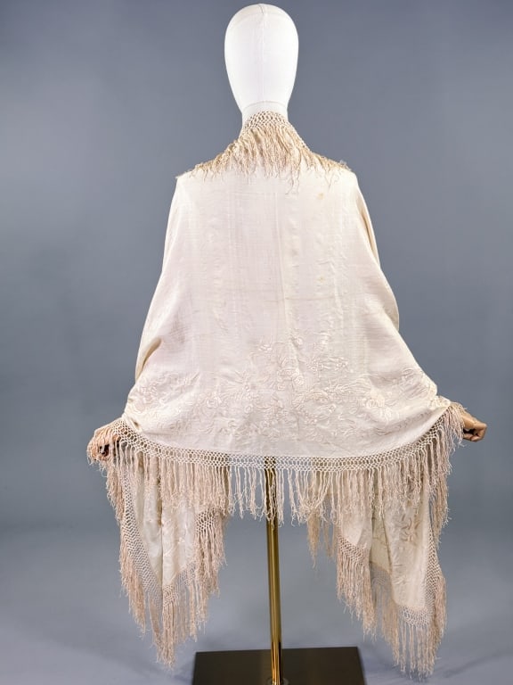 Antique 1920s Ivory Embroidered Piano Shawl Scarf: Antique 1920s Ivory Embroidered Piano Shawl Scarf having floral embroidery throughout and macrame fringed edges. Measuring approximately 70 inches long by 28 inches wide with 6 inch long fringe. Small