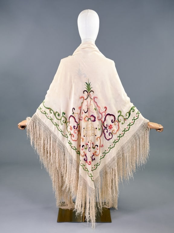 Antique 1920s Silk Embroidered Piano Shawl: Antique 1920s Silk Embroidered Piano Shawl having ivory ground with polychrome embroidery throughout and macrame fringed edges. Measuring approximately 62 inches by 58 inches with 10 inch long fringe.