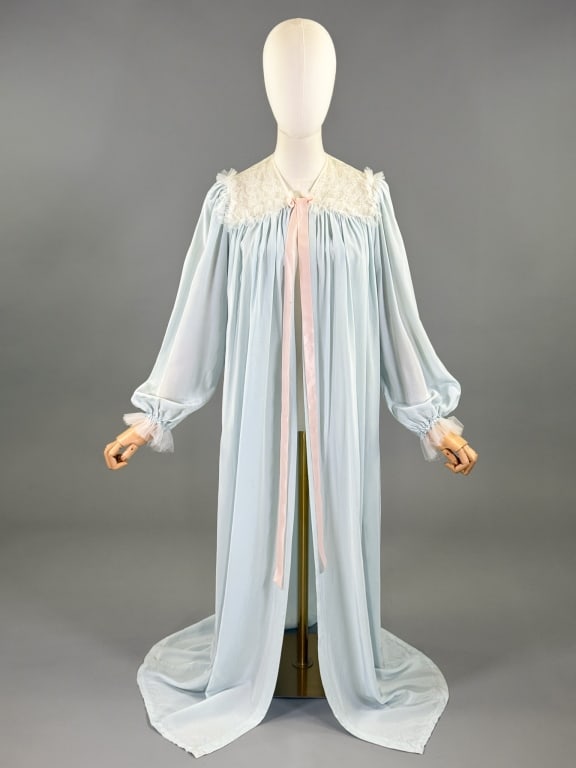 Vintage 1950s Blue Lace Peignoir Duster Robe: Vintage 1950s Blue Lace Peignoir Duster Robe having lace details at shoulders with ribbon tie closure at neck and elastic cuffs on bishop sleeves. Measuring 54 inches long, 26 inch sleeve length. Ligh