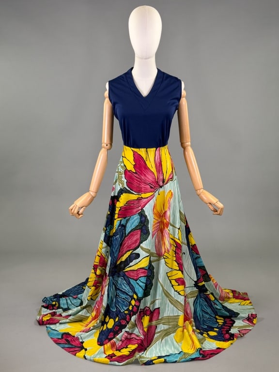 Vintage 1970s Poly Knit Floral Butterfly Dress: Vintage 1970s Poly Knit Floral Butterfly Dress having v-neckline with butterfly and floral printed maxi skirt, center back zip closure. Measuring 36 - 42 inch bust, 27 - 28 inch waist, 58 inches long.