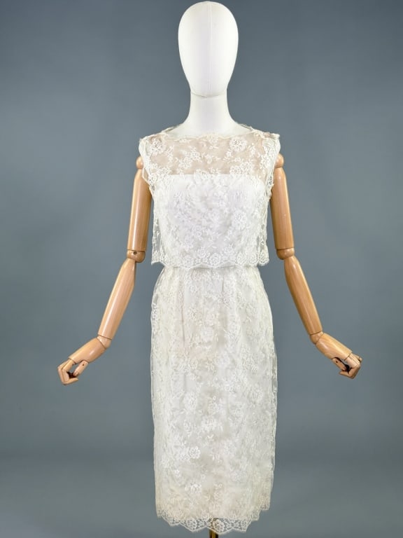 Vintage 1960s Estevez White Lace Cocktail Dress: Vintage 1960s Estevez White Lace Cocktail Dress having strapless illusion style neckline with lace overlay throughout and side zip and hook closures. Measuring 36 inch bust, 26 inch waist, 40 inches l