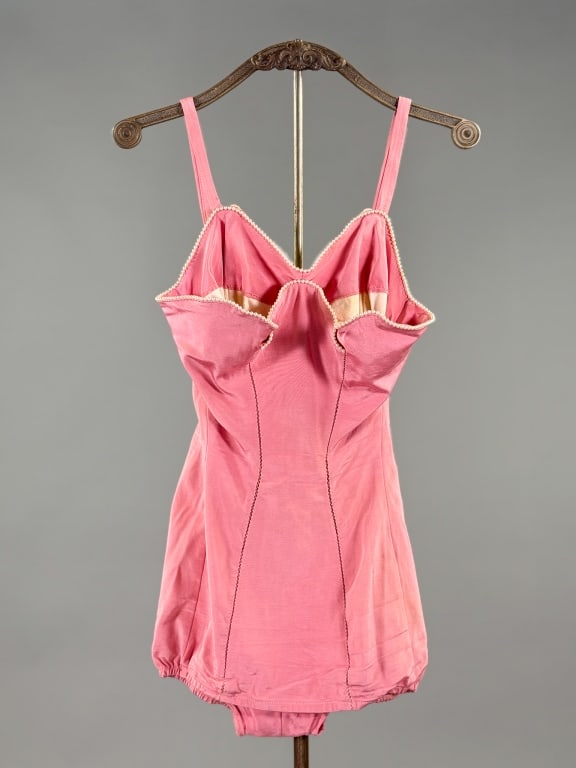 Vintage 1950s Rose Marie Reid Pearl Bathing Suit: Vintage 1950s Rose Marie Reid Pearl Bathing Suit having petal details at bust with pearl beaded trim and interior boned cups, closing with zip at center back. Marked size 10/32. Measuring 32 inch bust