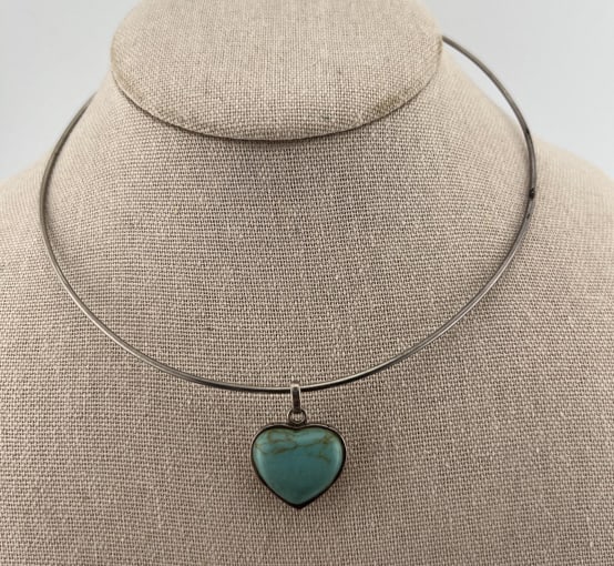 Native American Style Sterling Turquoise Pendant: Native American Style Sterling Turquoise Pendant. Heart form necklace pendant with turquoise, possibly treated or enhanced, hallmarked on the bail. With torque necklace. Heart measures just over 1 inc