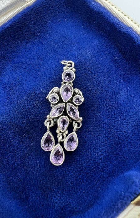 Amethyst & Sterling Silver Necklace Pendant: Amethyst & Sterling Silver Necklace Pendant. Necklace pendant with bezel set amethyst stones in pear shapes and round cuts set in sterling silver. Faintly hallmarked on the back. Measures just over 1.
