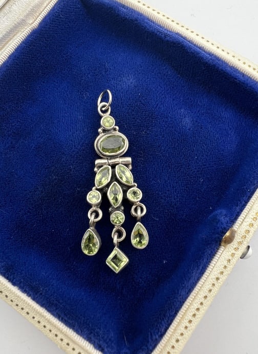 Peridot & Sterling Silver Necklace Pendant: Peridot & Sterling Silver Necklace Pendant. Necklace pendant with bezel set peridot stones in marquis cuts, oval and round cuts etc set in sterling silver. Faintly hallmarked on the back. Measures jus