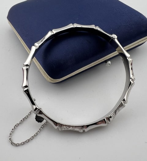 Vintage Faux Bamboo Motif Sterling Bangle Bracelet: Vintage Faux Bamboo Motif Sterling Bangle Bracelet. Hinged bangle bracelet with safety chain. Hallmarked. Measures just over 2.25 inches across the interior opening.