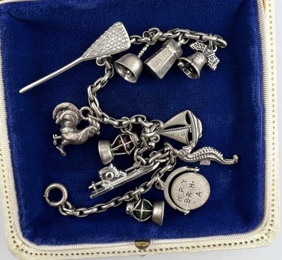 Vintage Sterling Charm Bracelet Charm Collection: Vintage Sterling Silver Charm Bracelet w Charm Collection. Including; lantern, happy birthday spinner, sea horse, skis, sail boat, a second lantern, a rooster, lacrosse stick, bell, light house and li
