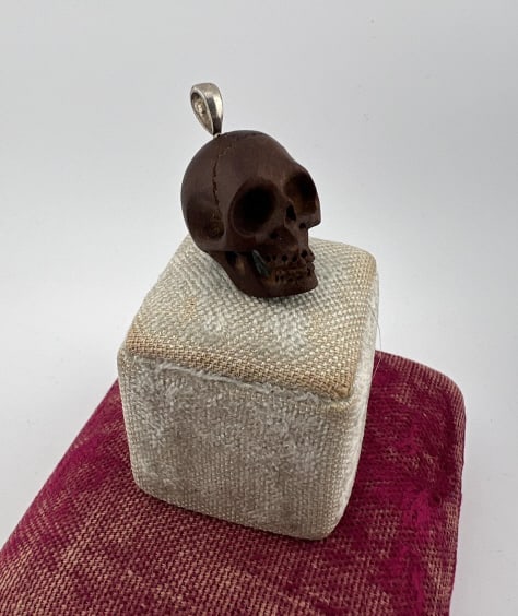 Sterling & Carved Wood Memento Mori Skull Pendant: Sterling Silver & Hand Carved Wood Memento Mori Skull Necklace Pendant. Hallmarked on bail 925. Nicely detailed realistic wood carving. Measures just over an inch in length.