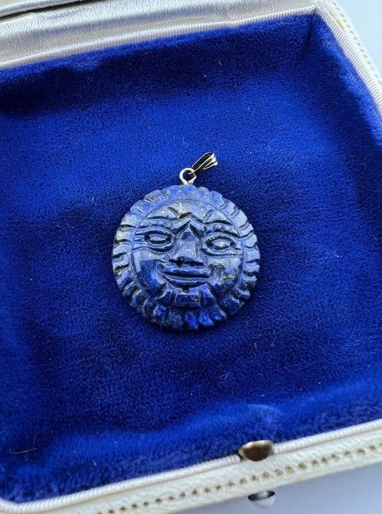 Sterling Silver & Lapis Lazuli Carved Sun Pendant: Sterling Silver & Lapis Lazuli Carved Sun Pendant. Hand carved sun motif necklace pendant in lapis lazuli with sterling silver bail. Measures just over 1.25 inches in length.