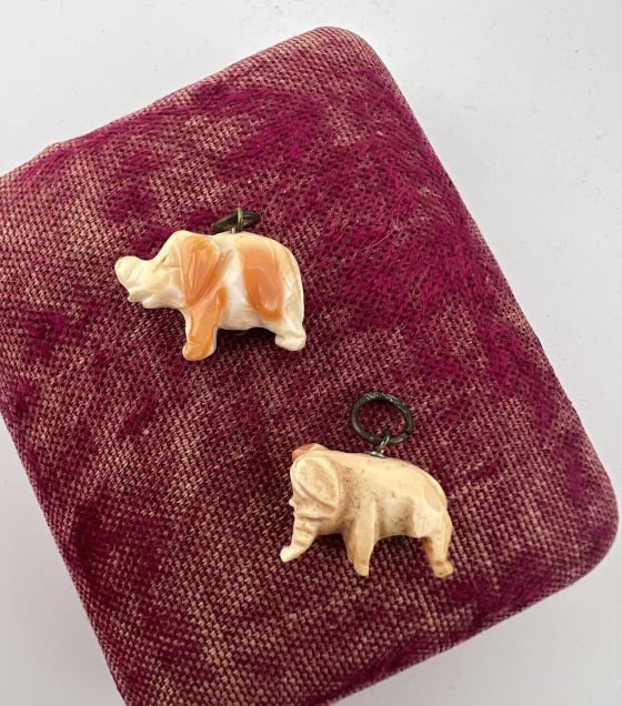 Two Antique Hand Carved Coral Elephant Pendants: Two Antique Hand Carved Coral Elephant Pendants. Each with bail. Approximately .75 and 1 inch in length.