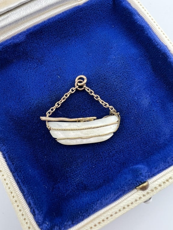 Antique 19th C Gold Filled Mother of Pearl Pendant: Antique 19th C Gold Filled & Carved Mother of Pearl Pendant. Figural boat necklace pendant. Measures 1 inch in length and 1.25 inches in width.
