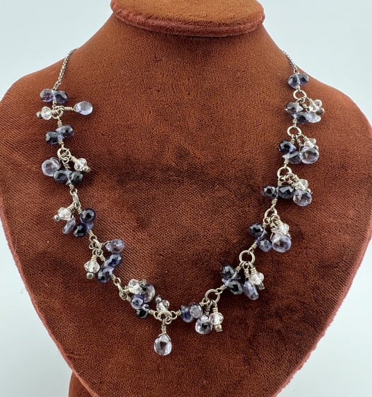 Sterling Silver & Briolette Cut Amethyst Necklace: Sterling Silver & Briolette Cut Amethyst Necklace. Hallmarked on the clasp. Rolo link necklace with hand cut briolette pear shape stones in wire wrap settings including amethyst. Measures 18 inches in