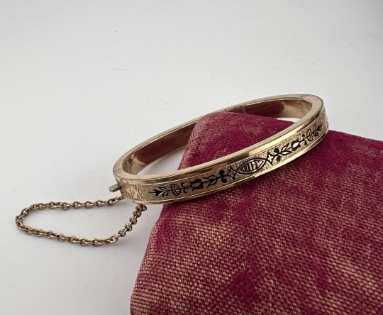 Antique 19th C Gold Filled Black Enamel Bracelet: Antique 19th C Gold Filled Black Enamel Bracelet. Hinged bangle bracelet with safety chain. Measures just under 2.25 inches across the interior opening.