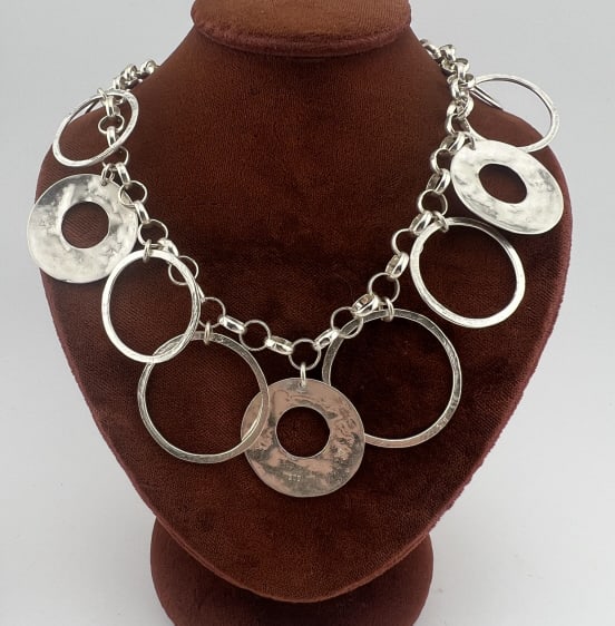 Modernist Sterling Multi Ring Design Necklace: Modernist Sterling Silver Multi Ring Design Necklace. Hallmarked. Measures 17 inches in length. Weighs approximately 30 grams.
