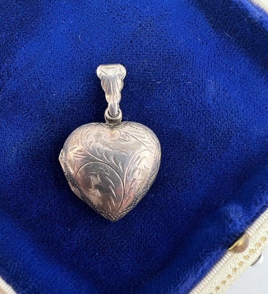 Vintage Sterling Silver Puffy Heart Locket Pendant: Vintage Sterling Silver Puffy Heart Locket Pendant. Engraved with scrollwork design front and back. Measures just over 1.25 inches in length.