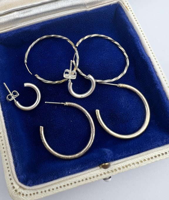 Three Pairs of Vintage Sterling Hoop Earrings: Three Pairs of Vintage Sterling Hoop Earrings. Larger size measures 1.25 inches in diameter.