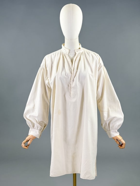 Antique 19th C Cotton Men's Under Shirt Top: Antique 19th C Cotton Men's Long Sleeve Under Shirt Top having three quarter button closure at neck. Measuring 48 inch chest, 35 inch front length, 37 inch back length, 21 inch sleeve length. Wear