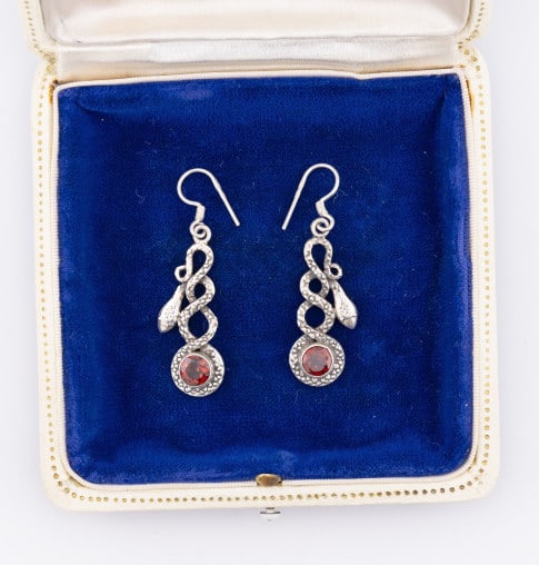 Pair Sterling Silver & Garnet Snake Motif Earrings: Pair Sterling Silver & Garnet Snake Motif Earrings. Hallmarked on ear wire and pendant. Each measures 1.75 inches in length.