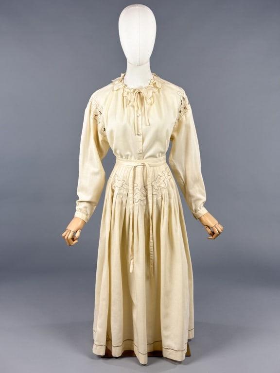 Vintage 1970s Ivory Wool 2 Pc Leaf Skirt Top Set: Vintage 1970s Ivory Wool 2 Pc Leaf Skirt Top Set having top with button front closure and embroidered leaf details with cutouts and pleated skirt with tie closure. Top measuring 38 inch bust, 22 inche