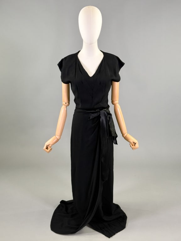 Vintage 1940s Crepe Bow Maxi Evening Gown: Vintage 1940s Crepe Bow Maxi Evening Gown having v-neckline with satin bow detail at waist with side zip closure. Measuring 34 inch bust, 26 inch waist, 58 inches long. Light wear throughout as shown.